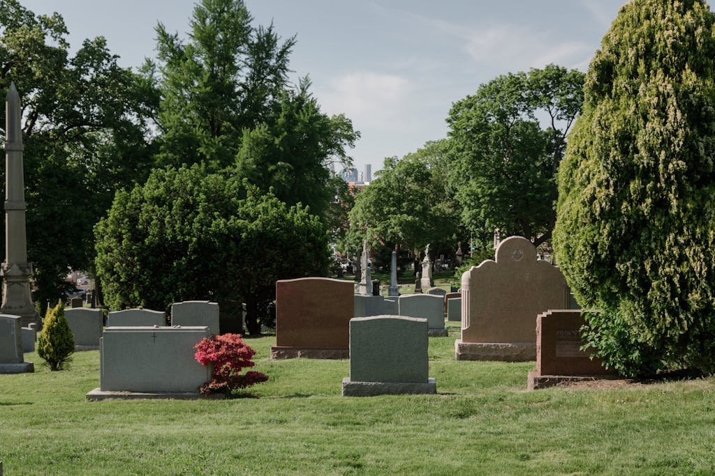Calm cemetery in San Francisco, CA with tombstones, headstones and lush greenery.