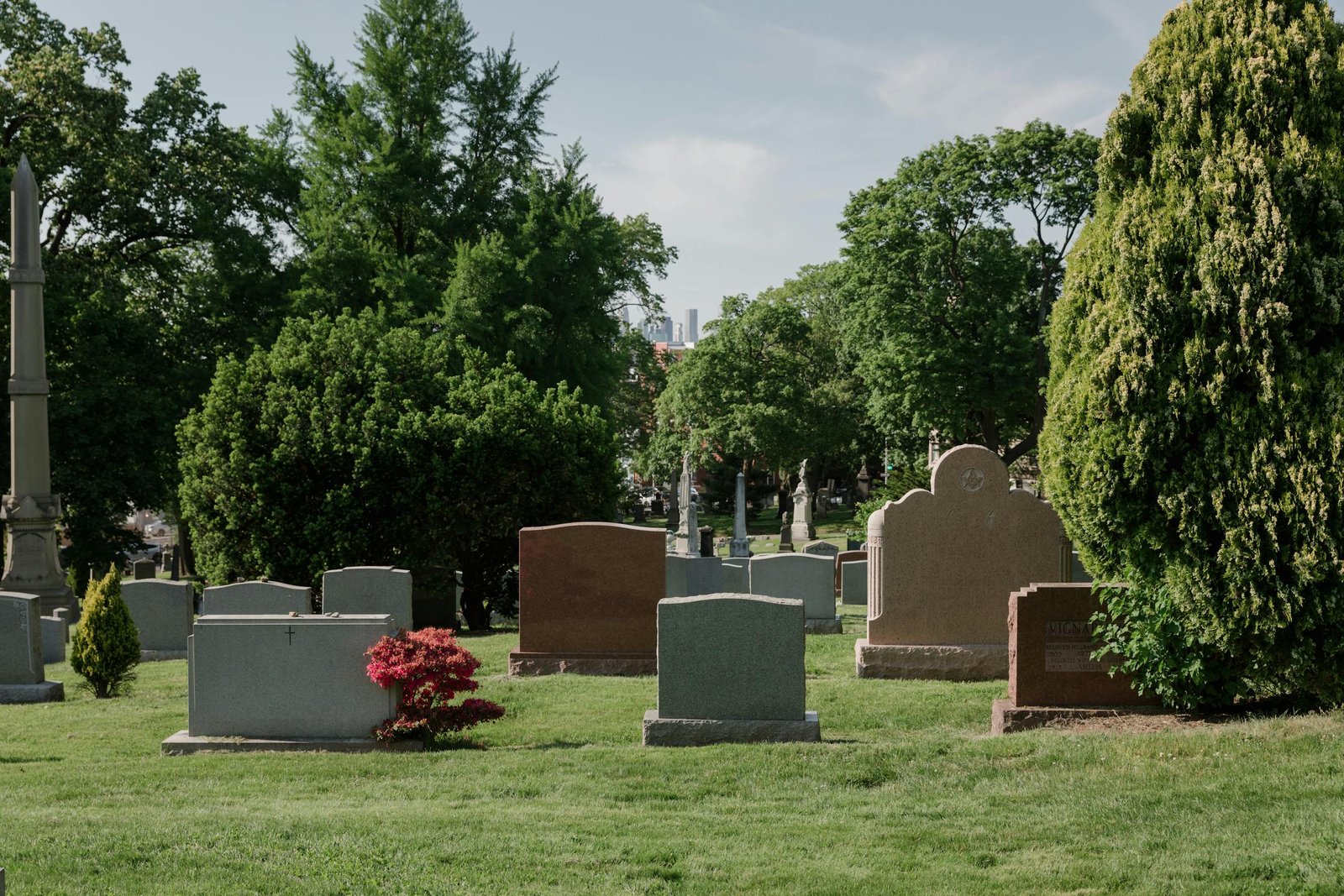 Calm cemetery in San Francisco, CA with tombstones, headstones and lush greenery.